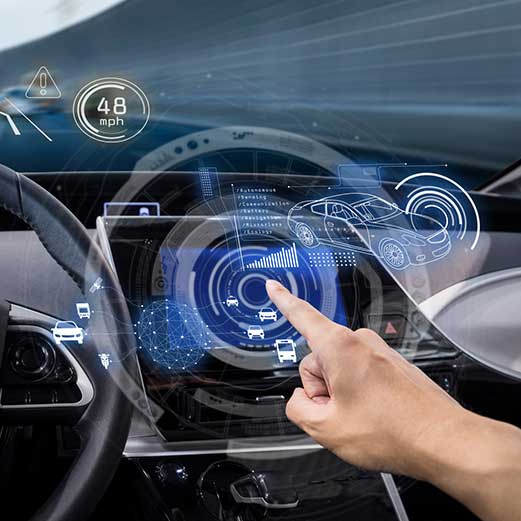 A hand uses a holographic car dashboard display showing speed, navigation, and nearby vehicles.