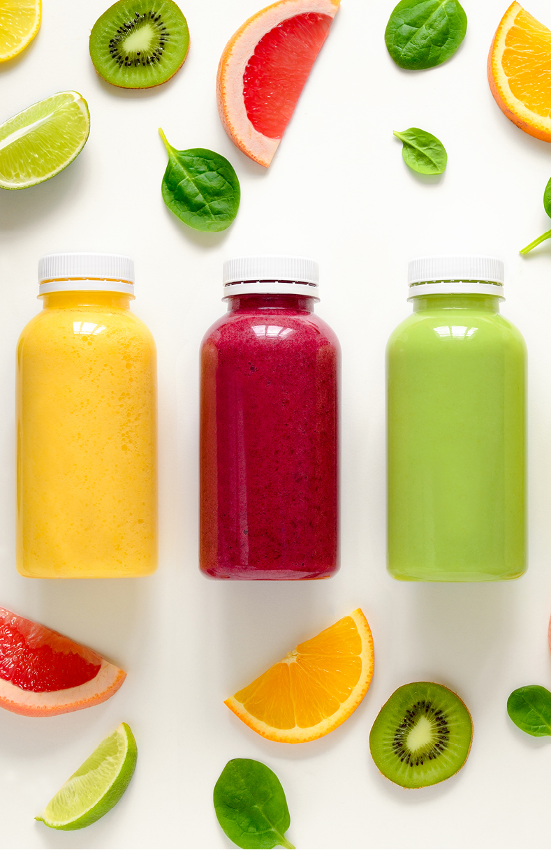 Various kind of smoothies or juices in bottles, healthy diet food concept, view from above